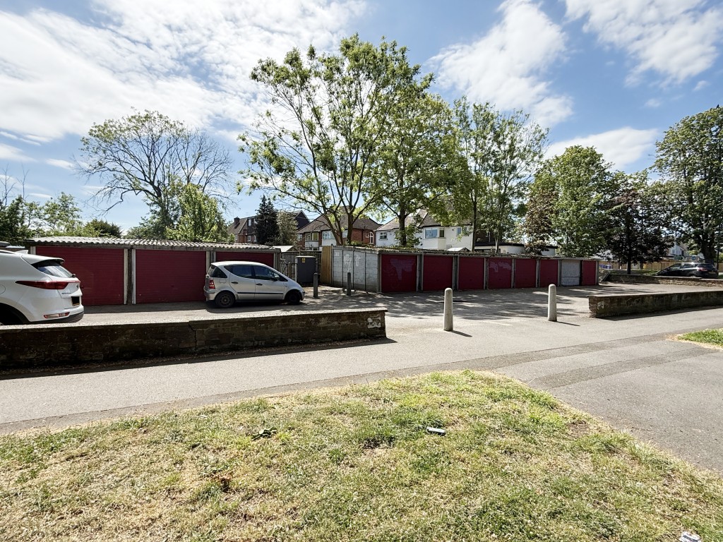 Lot: 13 - ELEVEN GARAGES AND LAND ON CORNER SITE WITH POTENTIAL - View of front of eleven garages